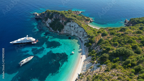 Aerial photo taken by drone of Caribbean tropical exotic steep cliff island bay with turquoise clear sea sandy beaches and rare limestone trees