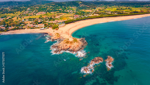 View from flying drone of Torre di Bari tower. Incredible morning scene of Sardinia island, Italy, Europe. Spectacular seascape of Mediterranean sea. Beauty of nature concept background.
