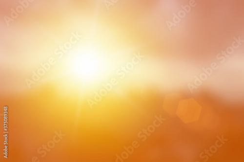Natural background blurring warm colors and bright glod sunlight. Bokeh or Christmas background Green Energy at sky sunny color orange light patterns plain abstract flare evening clouds blur.