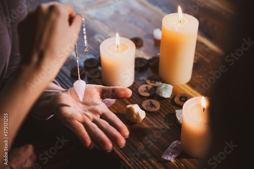 Librate with an pendulum over the hand, healing or oracle foretelling