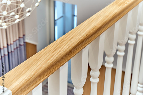 White balustrade. Wooden railing of a balcony with white balusters