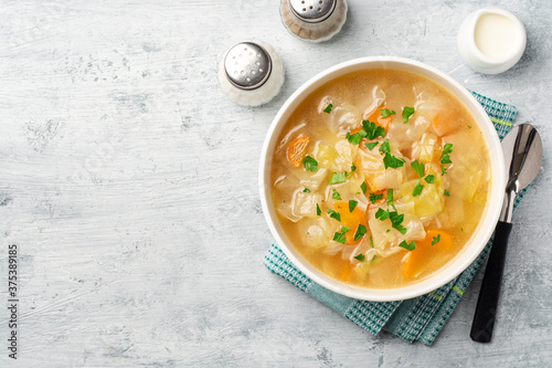 Homemade cabbage soup in bowl on concrete background