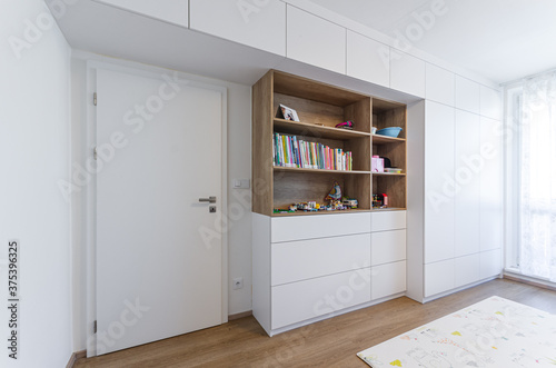 Cabinet shelf wardrobe in Children's room with toys and books