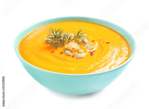 Tasty creamy pumpkin soup in bowl on white background