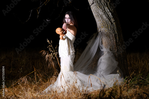 Horror Scene of a Woman Possessed holding a doll. High quality photo