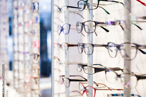 Image of glasses showcase at a modern optic shop, nobody