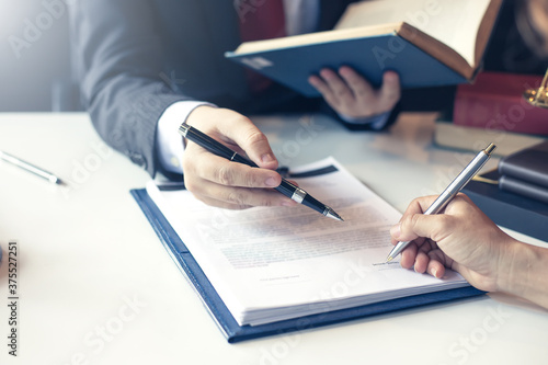 Lawyer pointing to the form signing of the contract agreement.