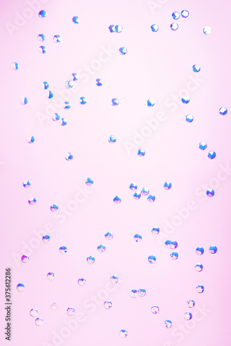 Colorful confetti on pink background. Happy new year celebration party. Greetings and congratulation concept. Festive backdrop with copy space for your design