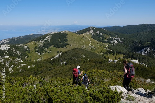 The beautiful Premuziceva Staza mountain path, Velebit National Park, Dinaric Mountains, Croatia. Silhouettes of walking tourist.