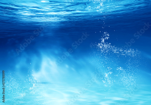BLUE UNDER WATER waves and bubbles. Underwater blue ocean background in sea. Underwater view of the sea surface. Abstract underwater scene and air bubbles in deep blue sea.