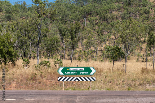 Indication panel on the road showing opposite directions: Katherine, Darwin. Green billboard with arrows. Stuart highway crossing the Australian outback, Explorers way, Northern Territory, Australia