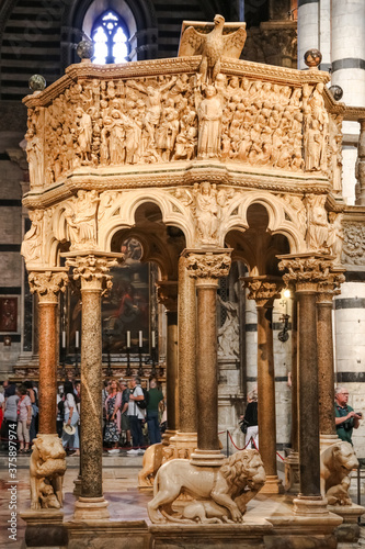 Great close-up view of the Siena Cathedral Pulpit. The octagonal structure with its seven narrative panels and nine decorative columns, was carved out of Carrara marble and sculpted by Nicola Pisano.