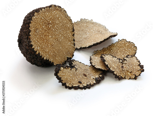 sliced fresh black truffle isolated on white background