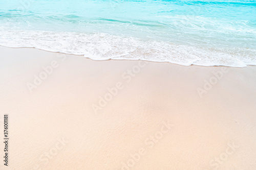 Tropical nature clean beach and white sand in summer with sun light blue sky and bokeh.