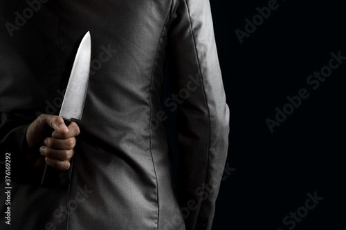 businessman hide knife behind back