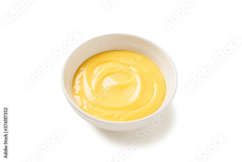 Homemade vanilla custard pudding or lemon curd in a white bowl isolated on white background