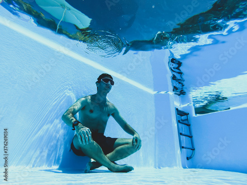 Man meditating apnea inside a pool