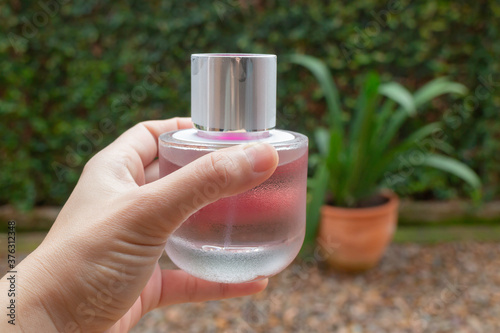 Woman hand show and hold perfume bottle