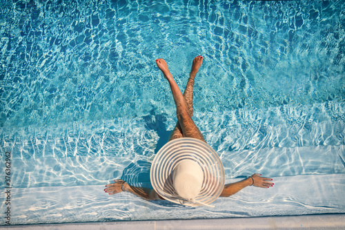 woman in luxury spa resort near the swimming pool.