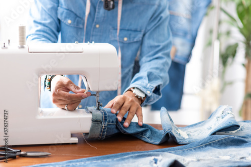 tailor working with jeans.