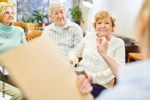 Doctor with questionnaire together with senior citizens