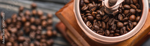 close up view of vintage coffee grinder with coffee beans, panoramic shot