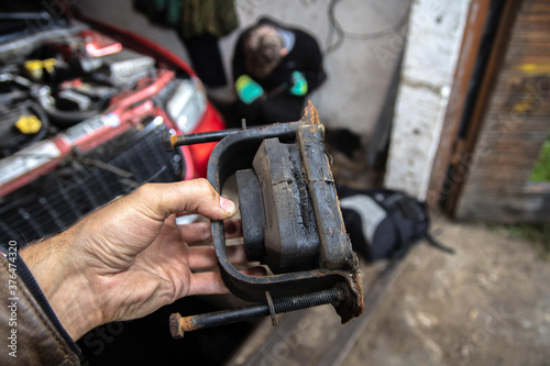 Torn faulty engine mount in the garage.