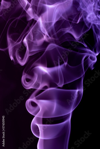 Violet abstract shaped smoke against black background. Abstract background