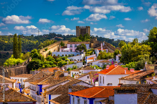 Historic walled town of Obidos, near Lisbon, Portugal. Beautiful streets of Obidos Medieval Town, Portugal. Street view of medieval fortress in Obidos. Portugal.