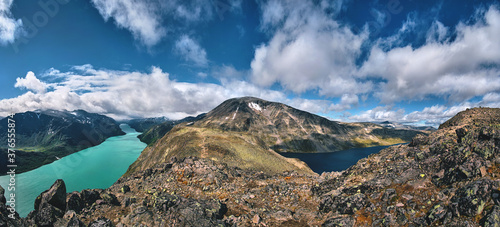 ultra wide panorama of the besseggen ridge trail over the gjende lake cliff on the mountains of jotunheimen national park Norway, panoramic