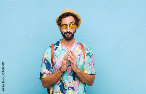 young bearded tourist man scheming and conspiring, thinking devious tricks and cheats, cunning and betraying