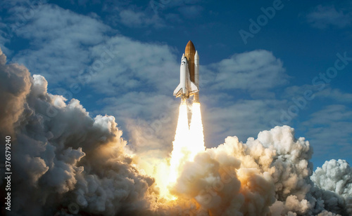 Spaceship takes off into the night sky on a mission. Rocket starts into space concept.Elements of this image furnished by NASA