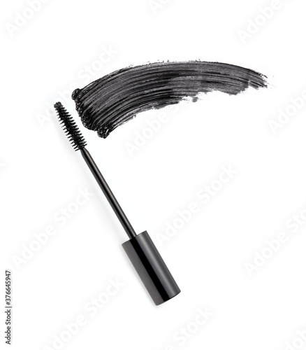 Black mascara brush stroke with applicator brush isolated on white 