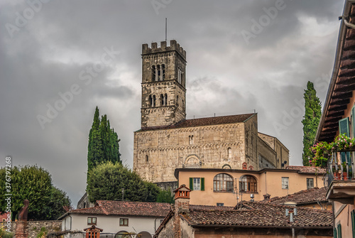 Exterior view of the Collegiate Church of San Cristoforo, known as "Duomo di Barga", seen across the roofs of the town of Barga, province of Lucca, Tuscany, Italy.