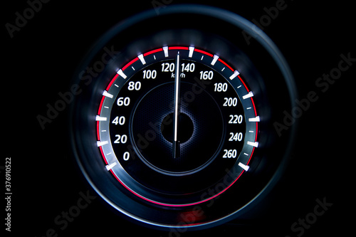 130 Kilometers per hour,light with car mileage with black background,number of speed,Odometer of car.