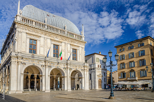 Palazzo della Loggia palace Town Hall Renaissance style building and street lights in Piazza della Loggia Square, Brescia city historical centre, blue sky background, Lombardy, Northern Italy