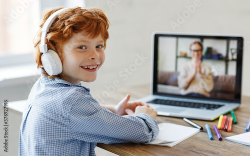 Cheerful boy during online lesson at home.