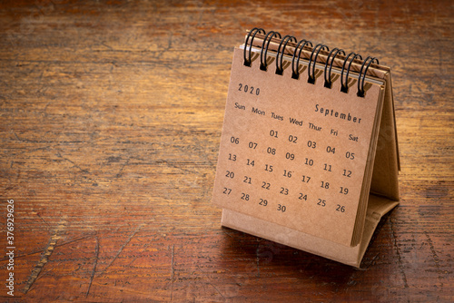 September 2020 - spiral desktop calendar on rustic, weathered wood, time and business concept