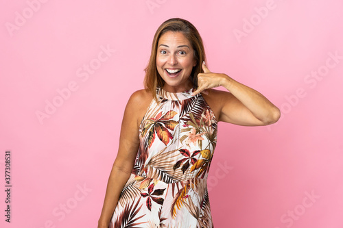 Middle age brazilian woman over isolated background making phone gesture. Call me back sign