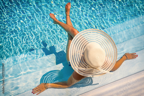 woman in luxury spa resort near the swimming pool.