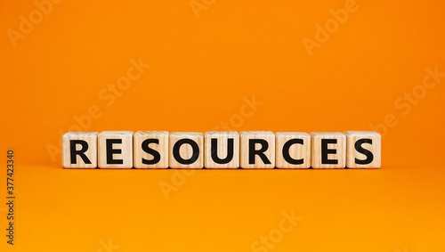 Wooden cubes with word 'resources'. Beautiful orange background. Business concept. Copy space.