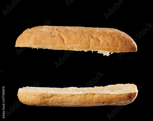 halved baked ciabatta loaf isolated on black background, sandwich blank