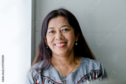 Portrait of asian woman 60s smile looking camera at home during covid19 coronavirus.Stay home and Lockdown.Senior christian woman. Senior Adult Women Smiling happy with retirement life.Dental care.