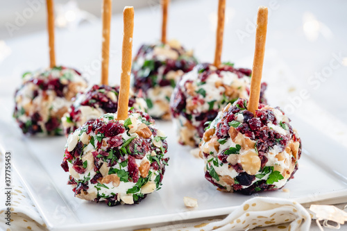 Christmas cheese ball appetizers with cranberries, pecans and herbs.