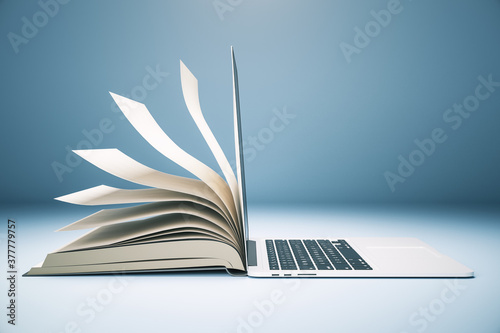 Abstract book and open laptop.