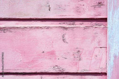 Wood texture background. Old wood and peeled paint in pink