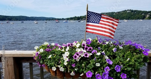 Water Views with an American Flag Blowing in the Breeze and Flowers in the Foreground; Vacation and Travel Destinations