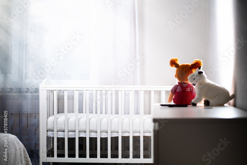 Children's room with an empty cradle and toys on the dresser. Copy space. The concept of abortion and female infertility