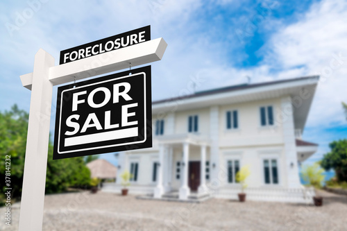 Black Foreclosure Home For Sale Real Estate Sign in front of a white mansion or villa.