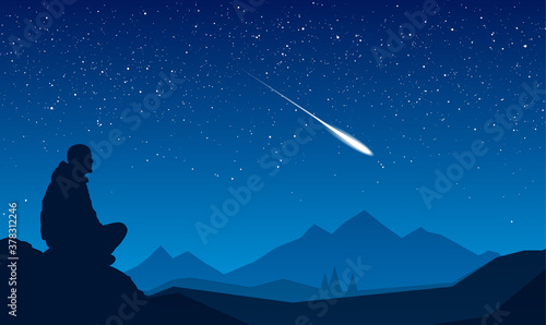 Traveler sitting on the stone and looking at the starry sky. Night mountains landscape with meteor.